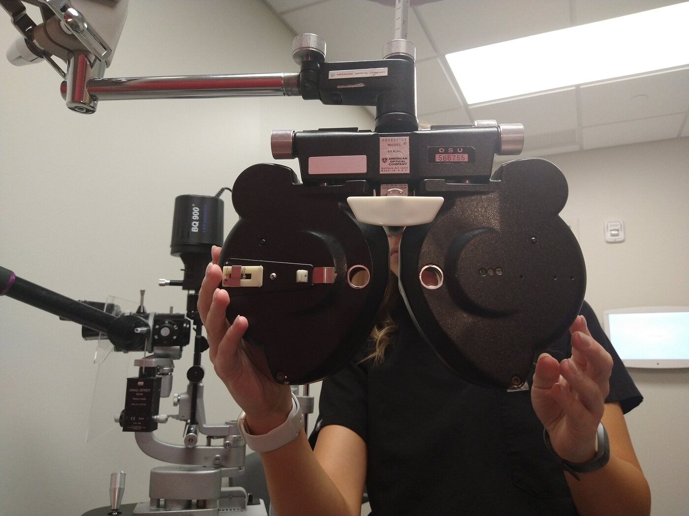 Optometry student learning to use clinical eye examination equipment