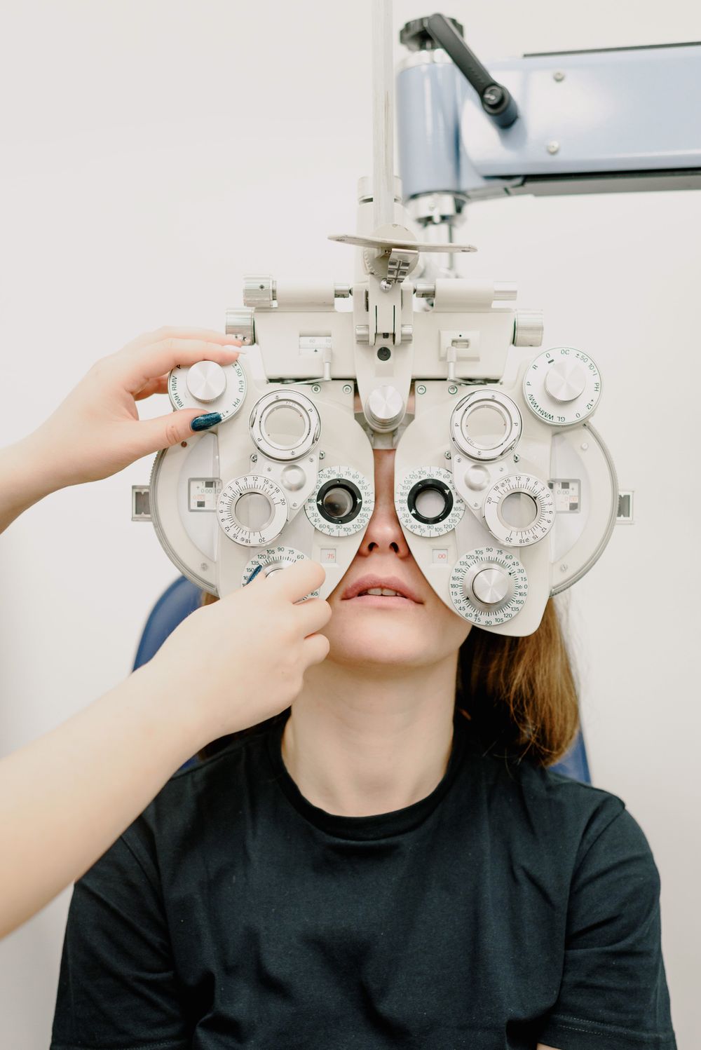 Patient looking through a phoropter during an optometry appointment